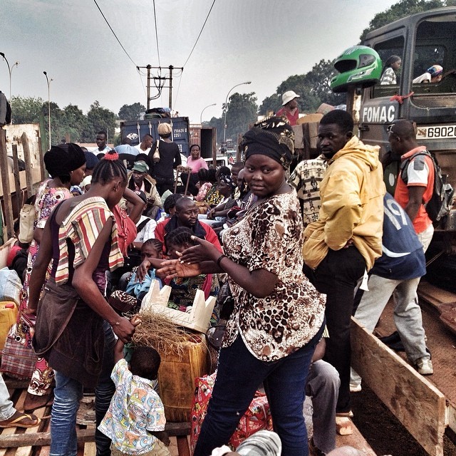 March 2014, people get ready to leave Bangui by convoy secured by the Misca. Twice a week, hundreds of Muslims and non Muslims flee the capital because of the violence. They will spend at least 2 days on trucks or in containers to reach the border with Cameroun. #CARcrisis #centralafricanrepublic #Refugees #fleeing