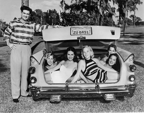 Five girls in the trunk of a 1957 Dodge Royal Lancer.