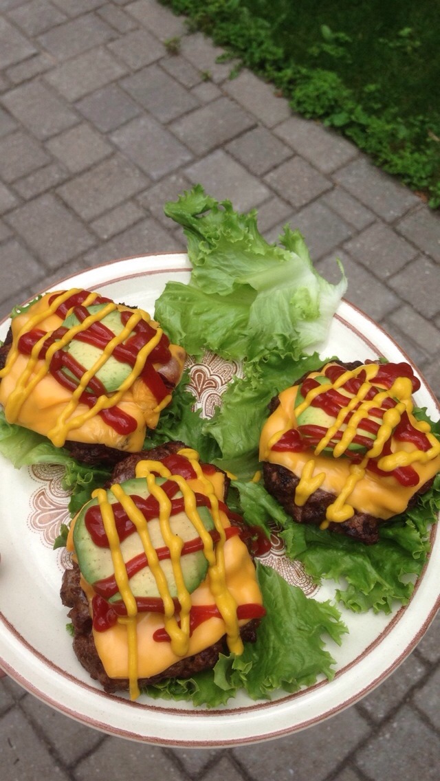Lay me down on a bed of lettuce.

Low carb burgers. Yes, that is bacon you see creeping out from under the cheese.