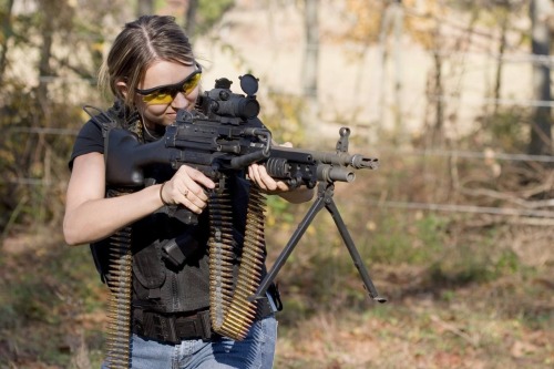 Little girl shooting machine gun