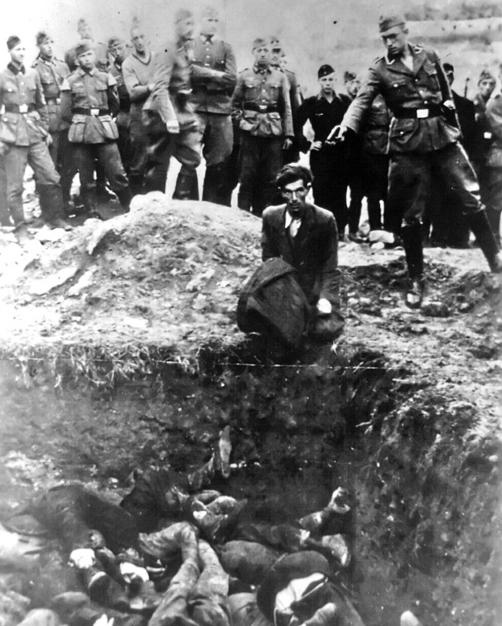 In this iconic World War 2 photograph, a member of Einsatzgruppe D – a Nazi paramilitary group – is about to shoot a Jewish man kneeling before a filled mass grave in Vinnitsa, Ukraine, in 1942. All 28,000 Jews from Vinnitsa and its surrounding areas were massacred by German forces.