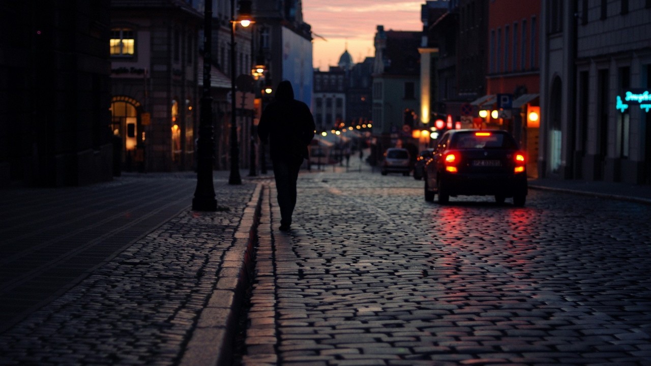 Man walking down the street at night