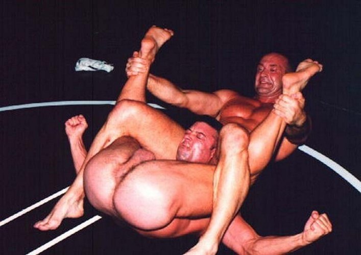 Naked military men wrestling