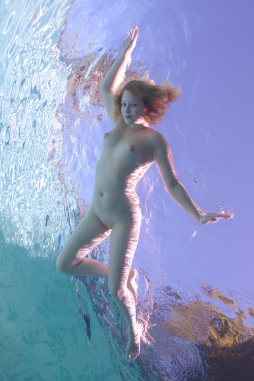 Naked girl underwater swimming pool