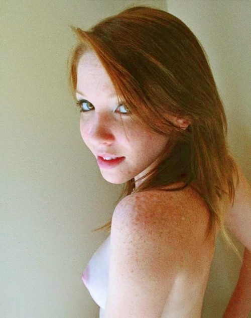 Freckled redhead teen posing