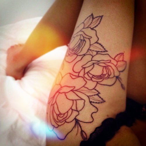 Flower skull thigh tattoo